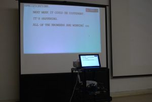A projector shows the text of a presentation at Accessibility Camp Toronto for the hard of hearing